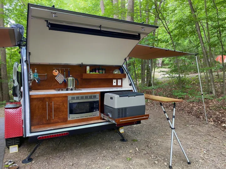 Experience camping comfort! This RV rental offers an amazing outdoor kitchen with a sink, microwave, and fridge.. nuCamp T@G 2019