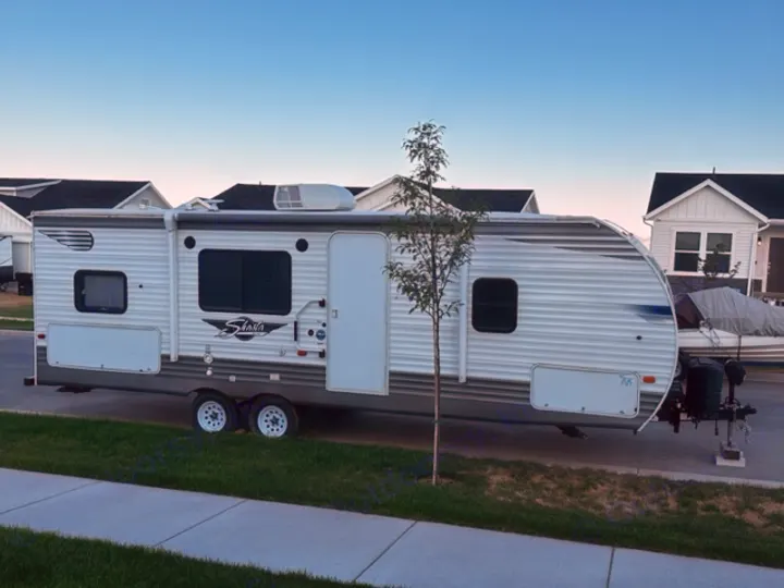 White Shasta RV rental travel trailer parked on a street. Ready for your next camping adventure!. Forest River Shasta 2021