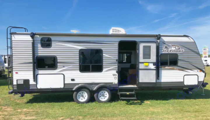 Jay Flight RV rental: A modern white and grey travel trailer with an open door and steps, perfect for your next camping trip.. Jayco Jay Flight 2017