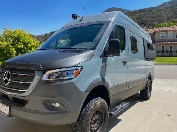 Customized grey Mercedes Sprinter adventure van, ready for off-road rv rental. Explore freedom in this stylish camper!. Mercedes Benz Sprinter 2500 2022