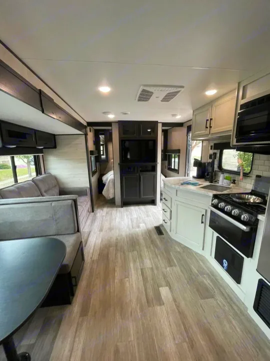 Step inside this modern RV rental featuring a full kitchen, comfortable dinette, and spacious living area. Ready for your trip!. Jayco Jay Flight Baja Edition 2023