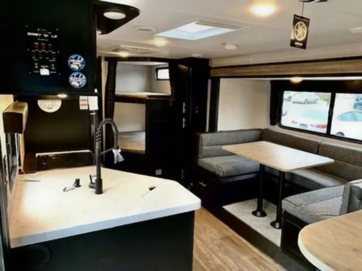 See inside this RV rental! Features a modern kitchen, U-shaped dinette, & bunk beds.. Forest River Cherokee Grey Wolf 2022