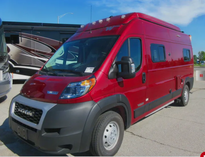 Bright red Winnebago ProMaster camper van, a compact motorhome perfect for your next RV rental adventure, parked outdoors.. Winnebago Solis 2021