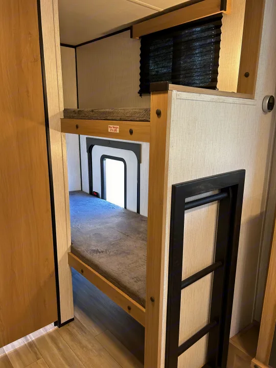RV rental bunk beds: two cozy tiers with a ladder. The top bunk has a 275 LBS max weight limit.. Cruiser RV Hitch 2022
