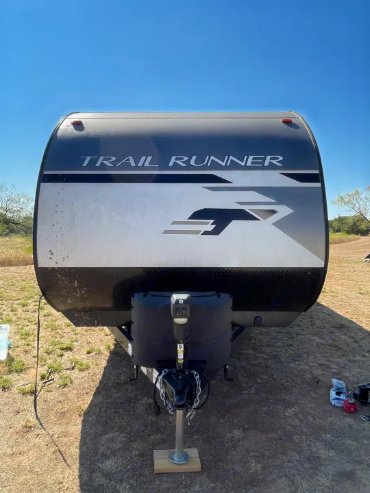 Front view of a 'Trail Runner' travel trailer parked outdoors. Perfect for your next RV rental adventure.. Heartland Trail Runner 2021