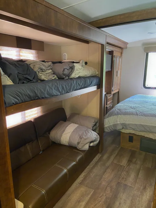 RV rental: Compact interior showing bunk beds, a sofa, and a master bed, optimized for comfortable mobile living.. Forest River Fr3 2017