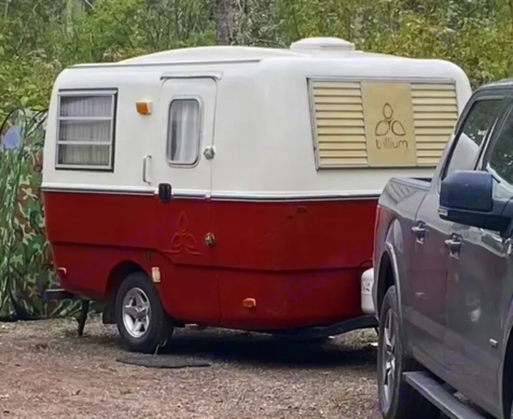 Classic red & white Trillium travel trailer, featuring its unique logo. Ideal for an RV rental or camping getaway.. Trillium Rv other 1975