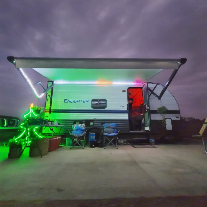 Exterior shot during the winter months, showing interior and exterior awning color changing LED lights. BOTH with remotes. Gulf Stream Enlighten 2021