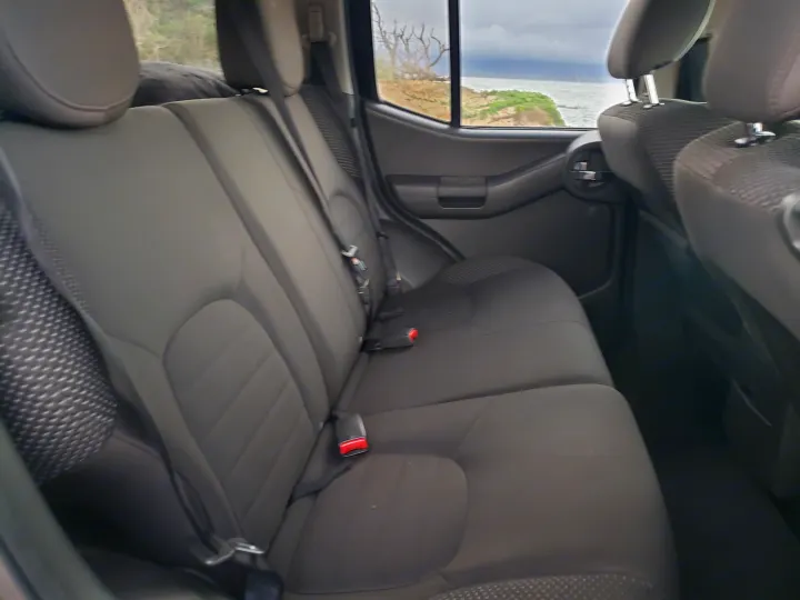 Dark grey vehicle rear seats with coastal view. Great for your next RV rental adventure.. Nissan Xterra 2012