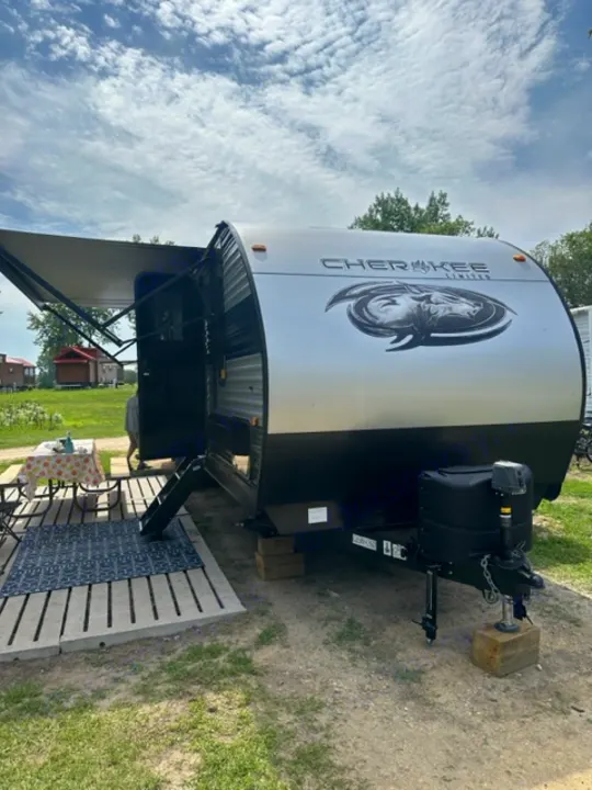 Cherokee travel trailer RV rental set up for camping, featuring an extended awning & outdoor patio.. Forest River Cherokee 2022