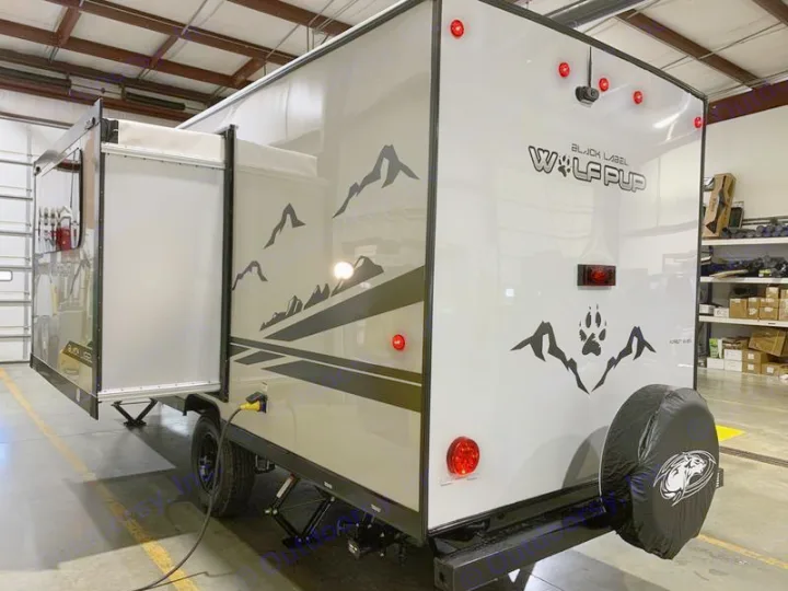 This Wolf Pup travel trailer, perfect for your next rv rental, features a slide-out, mountain graphics & rear spare.. Forest River Cherokee Wolf Pup Black Label 2021