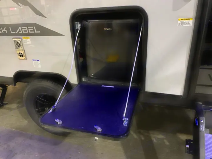 This RV rental features an outdoor kitchen with a Hotpoint refrigerator and a fold-down table for convenient outdoor use.. Forest River Cherokee Wolf Pup Black Label 2021
