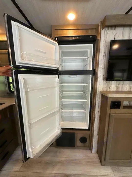 This RV rental features a spacious, open refrigerator and freezer, sparkling clean and ready for your provisions.. Forest River Surveyor Legend 2022