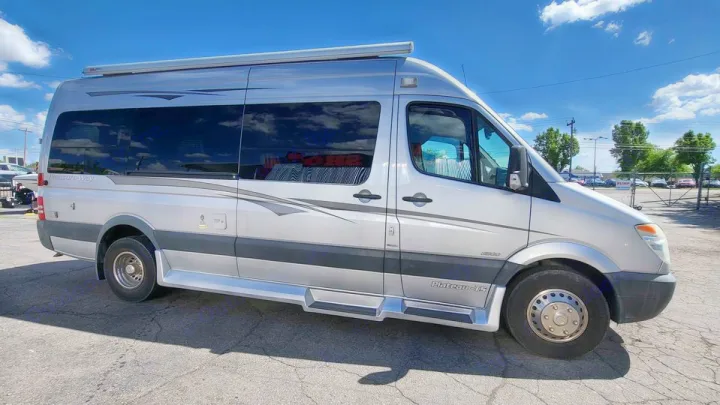 Luxury silver Mercedes-Benz Sprinter camper van, perfect for rv rental. Side view shows dark windows, awning & running boards.. Mercedes AS NEW SPRINTER 4 BERTH DISCOVERY AUTO TURBO DIESEL 2013