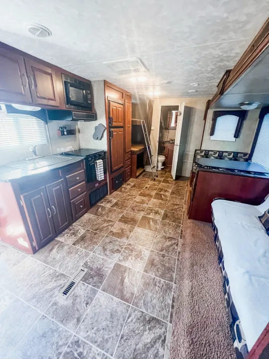 Spacious RV rental interior with full kitchen, dining area, bathroom, and bunk beds.. Forest River Wildwood 2011