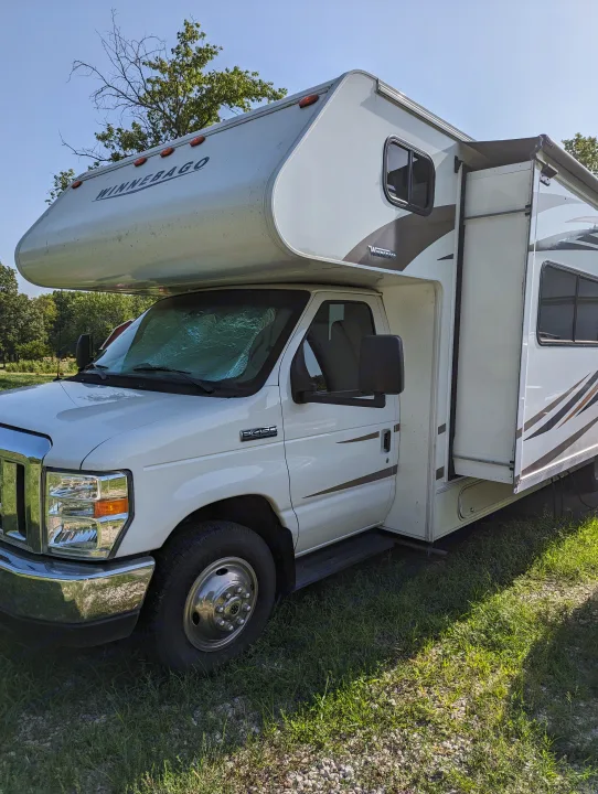 White Winnebago RV rental parked, with slide-out and awning partially extended. Ready for adventure!. Winnebago Spirit 2019