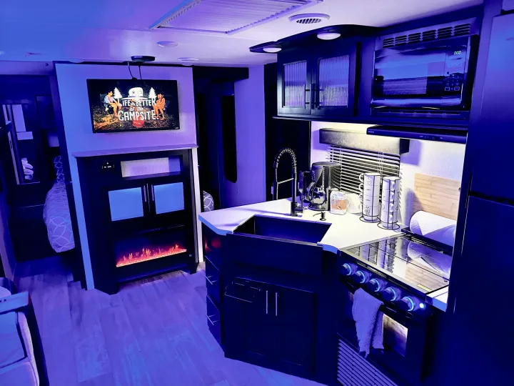 Step inside this RV rental! Features a fully equipped kitchen, living space with TV & fireplace, and cozy bunk beds.. Forest River Cherokee Grey Wolf Black Label 2021