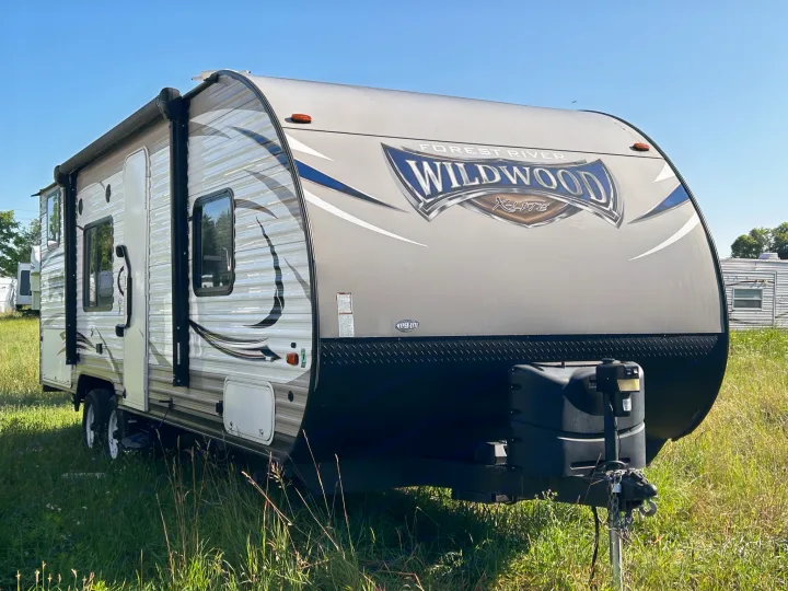Experience adventure with this Forest River Wildwood X-Lite RV rental, parked outdoors under a blue sky.. Forest River Wildwood X-Lite 2017