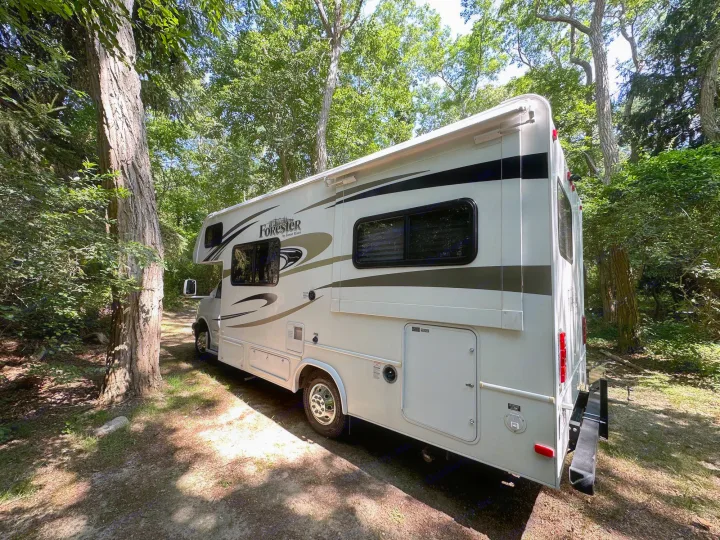 This RV rental is perfectly nestled in a shaded, wooded campsite. Your next adventure awaits in nature!. Forest River Chevy Express 2014