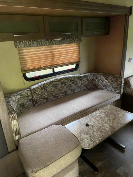 Cozy RV rental interior: dinette with patterned cushions, storage cabinets, and a compact table. Perfect for your next trip.. R-Pod R-Pod Trailer 2017