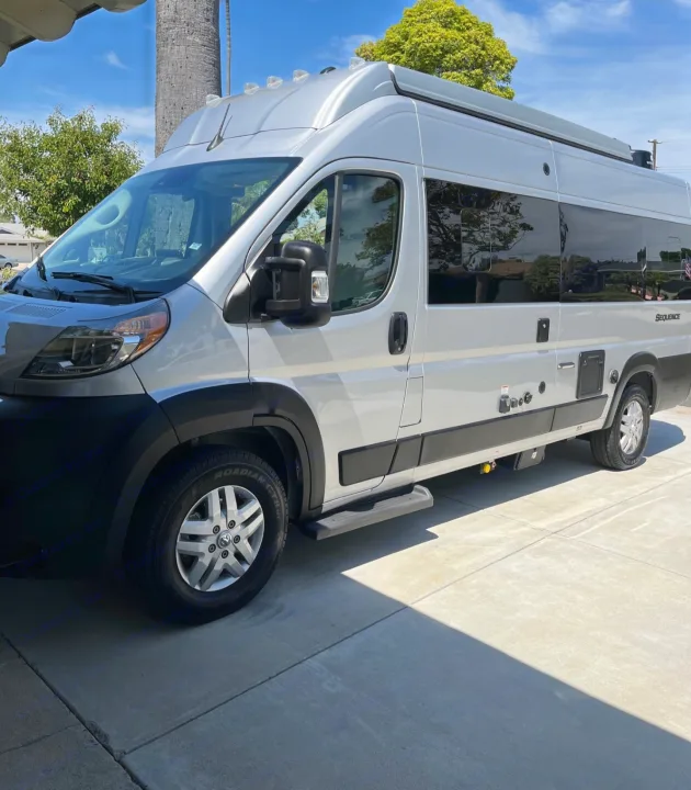 Silver Thor Sequence camper van, a perfect rv rental for your next road trip adventure, parked under a sunny sky.. Thor Sequnce 2023