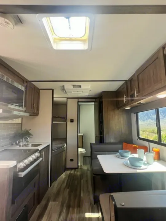 Spacious RV rental interior with kitchen, dining, and sleeping areas, offering comfort on the road.. Riverside Retro 190BH 2023