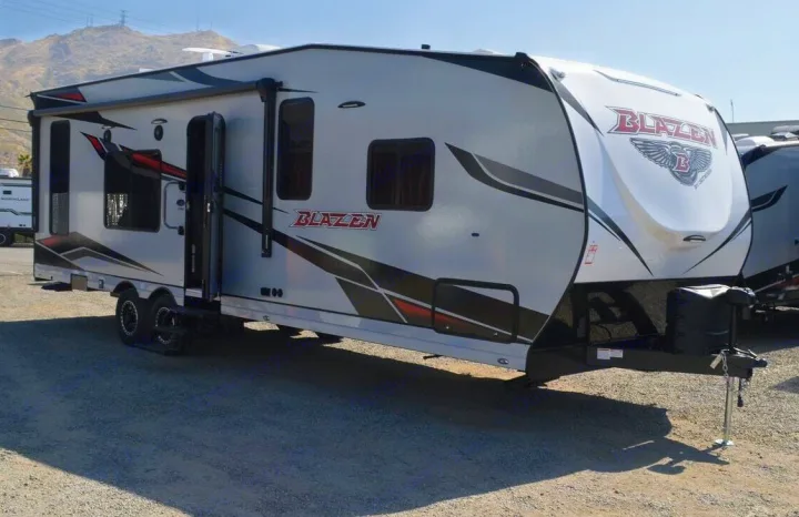 This Blazen RV, a grey toy hauler with graphics and an open door, is ideal for your next rv rental adventure.. Genesis Supreme Rv Genesis Supreme 2024