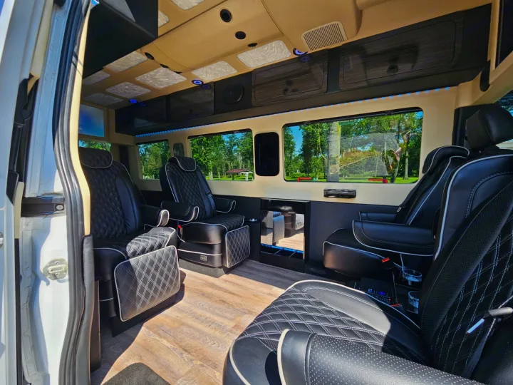 Experience this luxury RV rental: A custom van interior with quilted leather seats, wood floors, and ambient lighting.. Mercedes-Benz Sprinter 2017