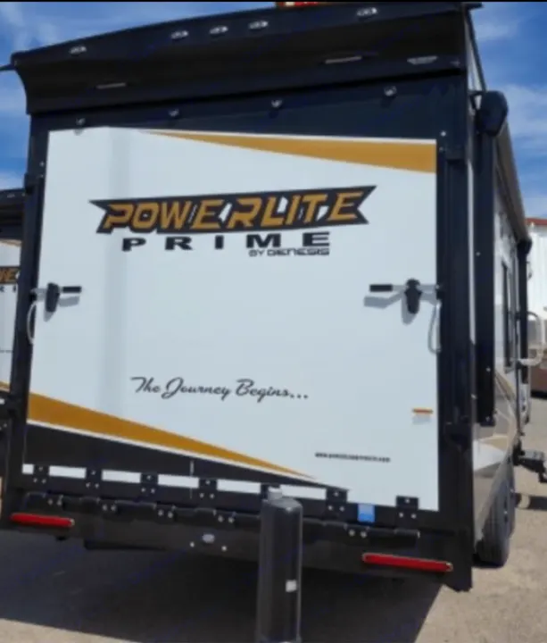 Rear view of a Powerlite Prime toy hauler RV, perfect for your next rv rental adventure, featuring a large ramp.. Genesis Supreme Rv Powerlite Prime 1915 2022