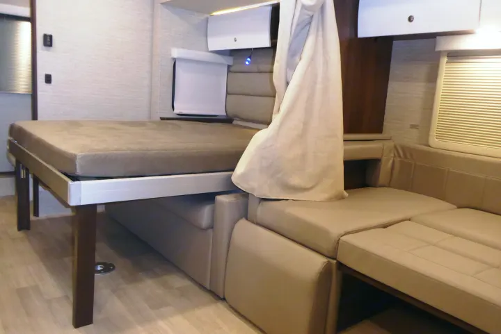 RV rental interior featuring a clever convertible bed above a plush sofa, optimizing compact living space.. Winnebago View 2023