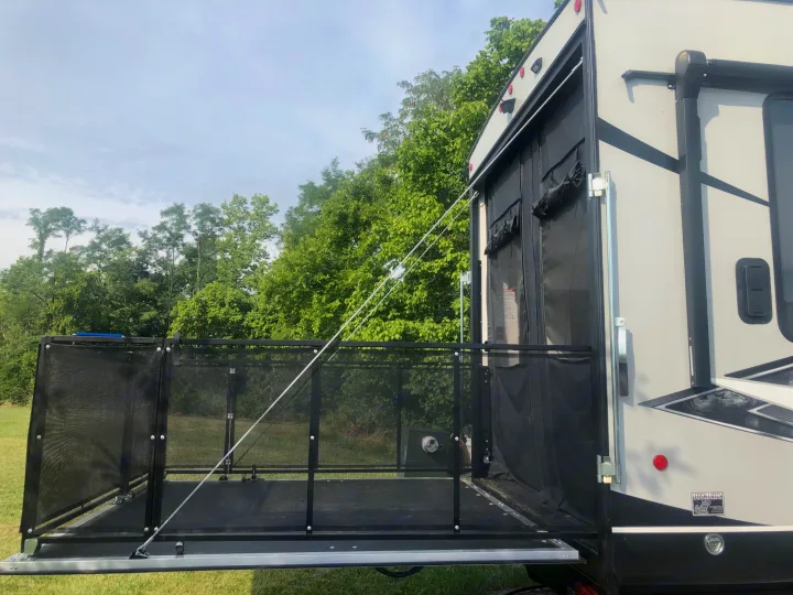 RV rental with a unique rear patio. This toy hauler's ramp converts to a deck with mesh railings, perfect for outdoor living.. Forest River Cherokee Wolf Pack Toy Hauler 2021