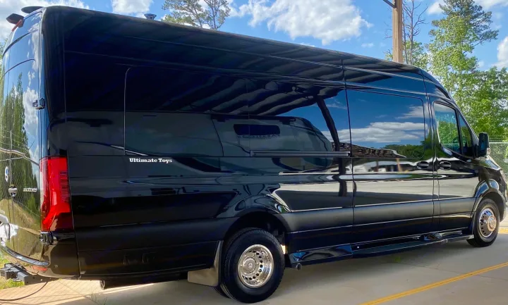 Sleek black luxury Mercedes Sprinter RV, perfect for your next rv rental. Features large tinted windows & shiny chrome wheels.. Ultimate Toys Ultimate Coach 2024