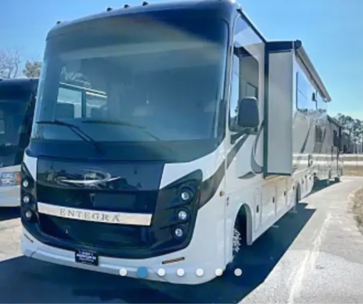 Spacious white and black Entegra RV, with extended slide-outs, perfect for your next rv rental adventure.. Entegra Coach Vision 2023