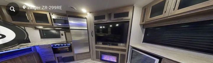 RV rental interior: full kitchen with stainless appliances, entertainment area with TV & fireplace, and ample storage.. Crossroads RV Zinger 2020