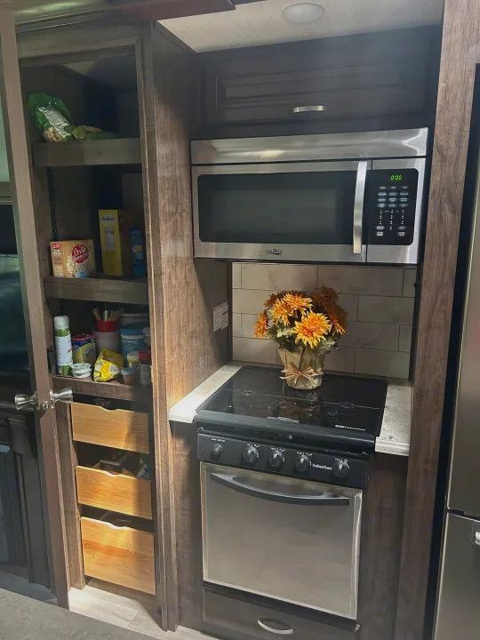 large pantry
microwave/convection oven and propane stove/oven. Grand Design Solitude 2018
