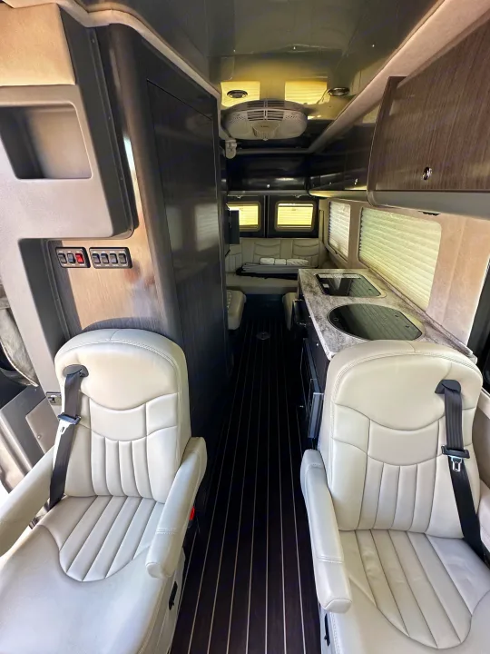 A table sits in the middle of the 4 captains chairs that swivel around to face each other. Airstream Interstate 2014