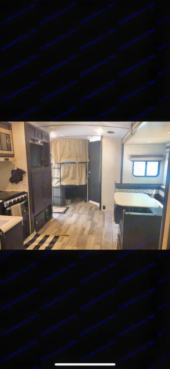 RV rental interior showcasing a full kitchen, bunk beds, and U-shaped dinette. Ideal for comfortable travel.. Forest River Legend 2019