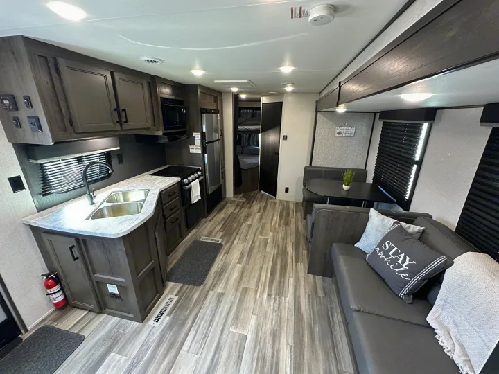 Spacious and modern RV rental interior featuring a full kitchen, dinette, and comfortable living area.. Starcraft Autumn Ridge 2022