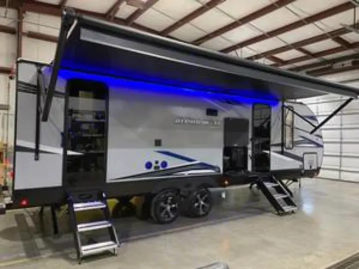 This Imagine travel trailer, perfect for RV rental adventures, features a lighted awning and steps.. Forest River Cherokee Alpha Wolf 2022