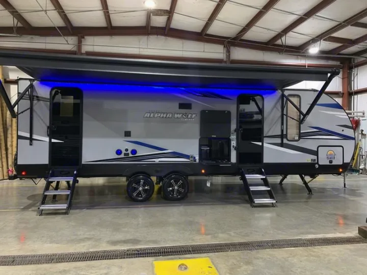 Alpha Wolf travel trailer with blue LED awning lights & extended steps.. Forest River Cherokee Alpha Wolf 2022