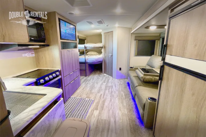 Step inside this rv rental: full kitchen, entertainment system, cozy reclining couch, and bunk beds for family comfort.. Grand Design Imagine 2021