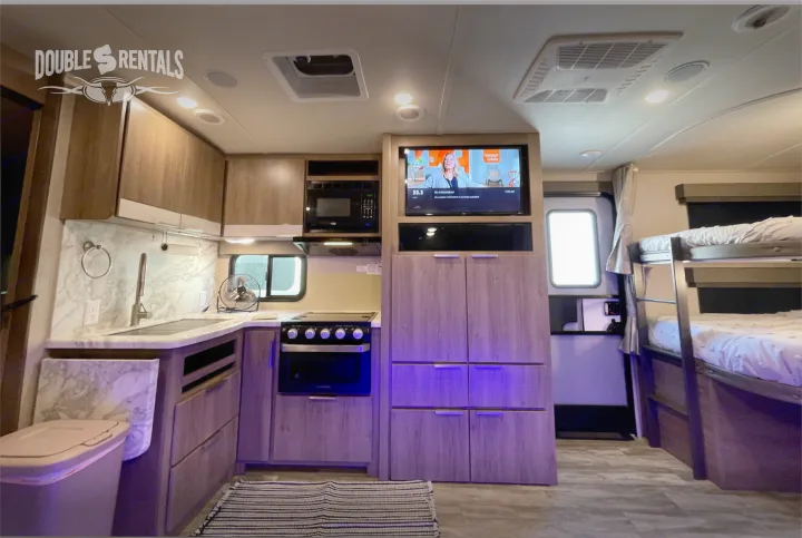 This modern RV rental features a full kitchen, TV, and comfortable bunk beds, perfect for family travels.. Grand Design Imagine 2021