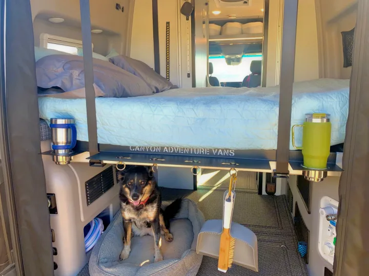 Inside this Canyon Adventure RV rental: a raised bed, dog lounging, and smart storage for your next road trip.. Winnebago Revel 2021