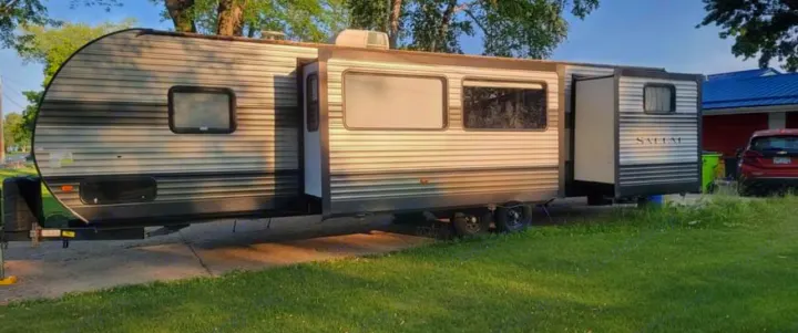 A Salem travel trailer RV rental with slide-outs extended, parked on a paved driveway.. Forest River Salem 2019