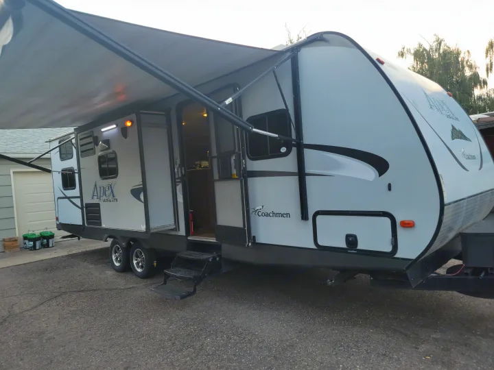 Coachmen Apex Ultra-Lite travel trailer setup for an RV rental. Awning extended, door open; ready for your next adventure.. Coachmen Apex 2015