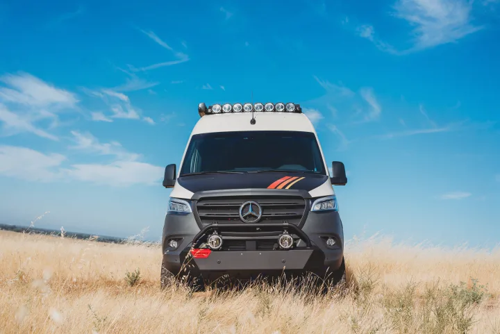 Custom Mercedes Sprinter adventure van, perfect for rv rental, parked in a golden field under blue sky.. Storyteller Overland Storyteller Overland Class B 2023