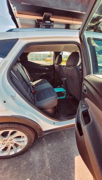 Preparing for adventure! White SUV with Thule rooftop tent & portable power station, ideal for car camping or an RV rental alternative.. Chevrolet Other 2023