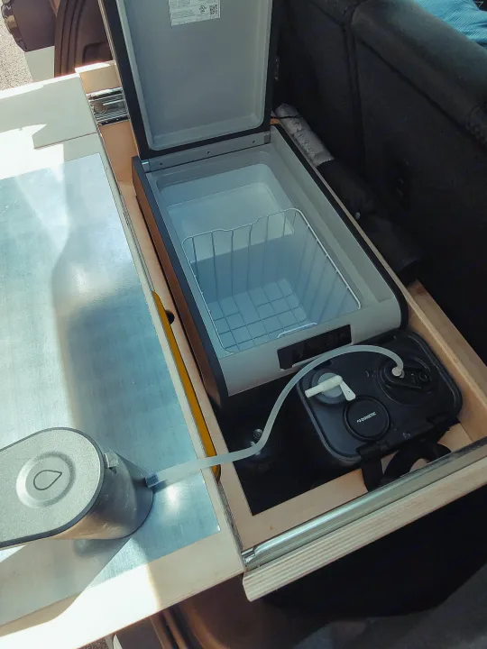 RV rental camp kitchen: Dometic portable fridge, water system, and slide-out drawer for easy access.. Chevrolet Other 2023