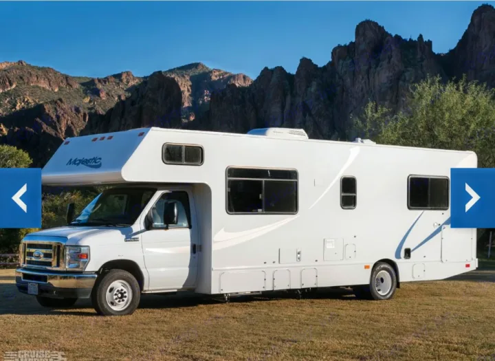 Majestic white Class C motorhome RV rental parked on grass with scenic mountains in the background.. Thor Majestic 2018