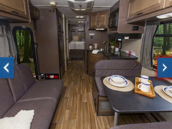 This RV rental interior features a full living space, kitchen, dining, and bed area for comfortable travel.. Thor Majestic 2018